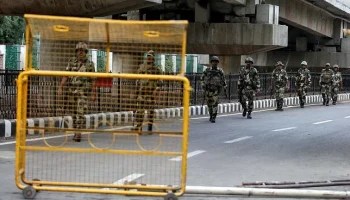 Indian security forces personnel patrol a deserted road during restrictions after the government scrapped special status for Kashmir, in Srinagar 7 August. Photo: AFP